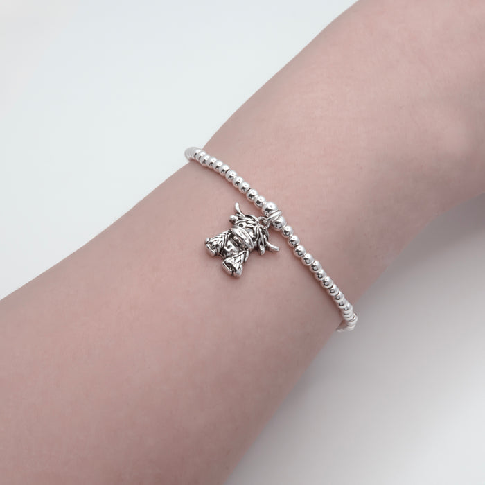 HC64 - Stretch Charm Bracelet with Silver Coloured Beads and Maisie Highland Cow Charm