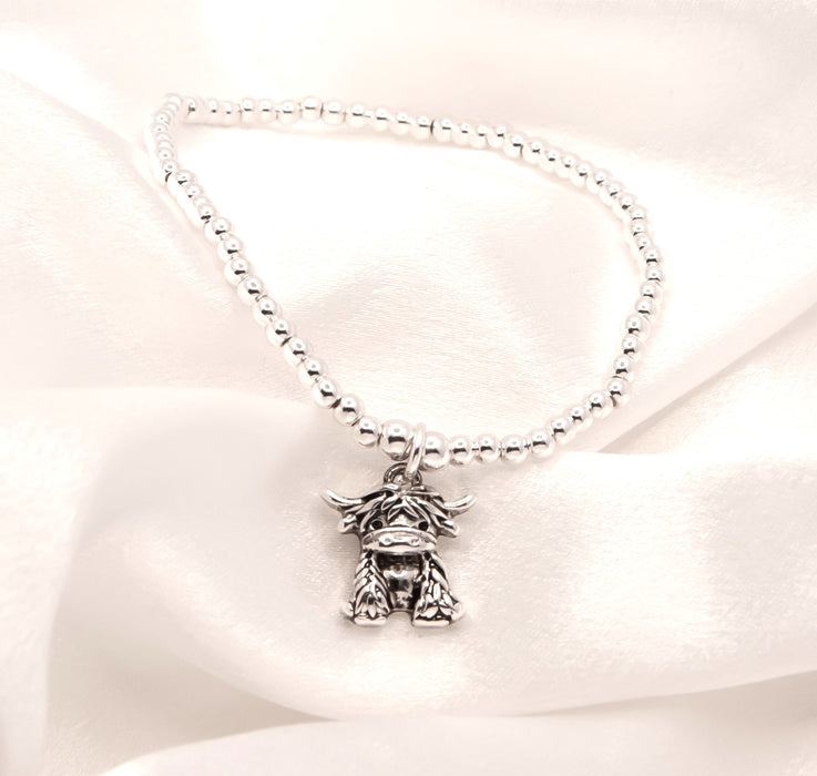 HC64 - Stretch Charm Bracelet with Silver Coloured Beads and Maisie Highland Cow Charm